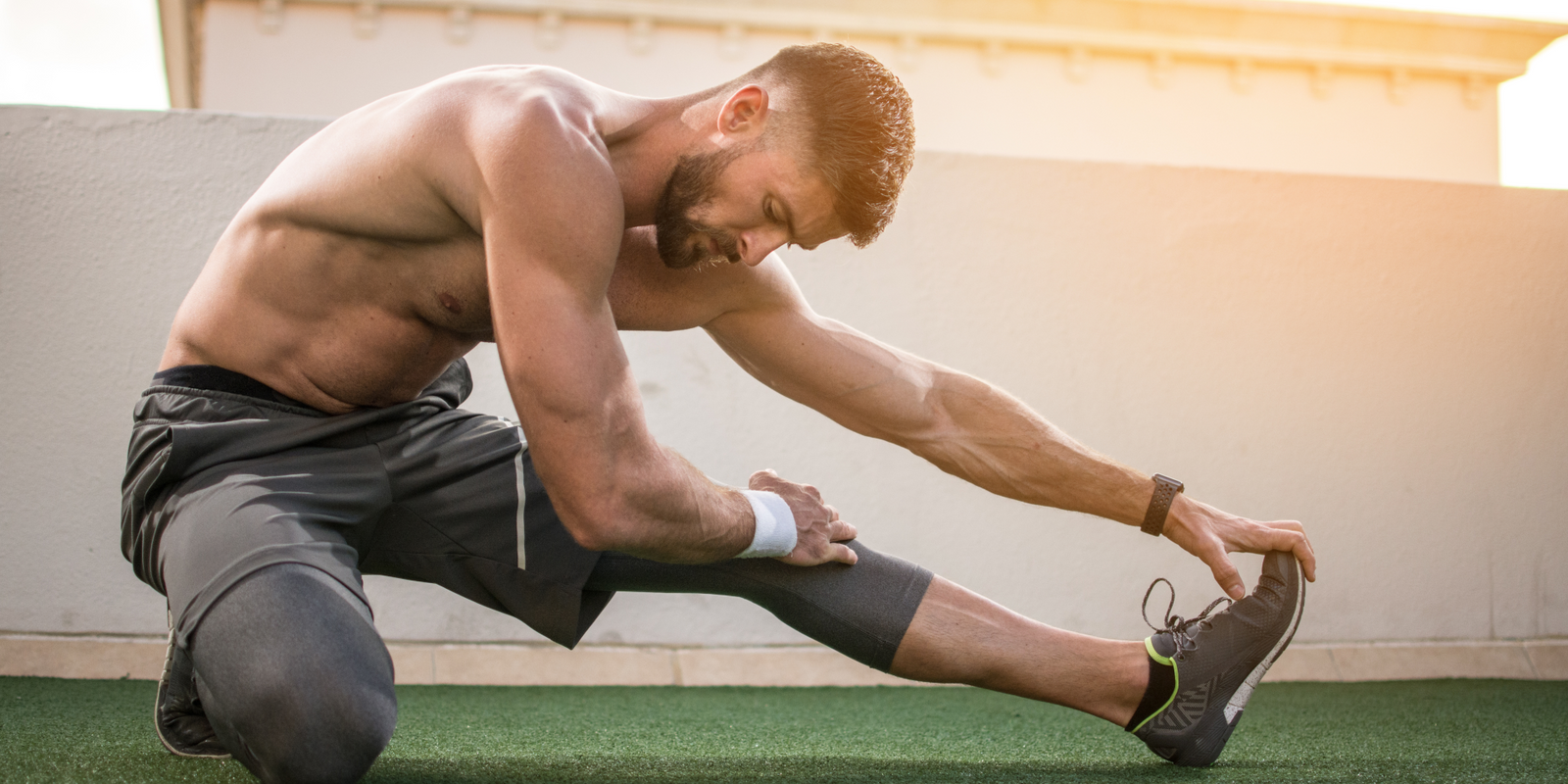 Man doing post-workout recovery stretches